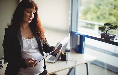 Illustration d'une femme enceinte qui regarde son calendrier